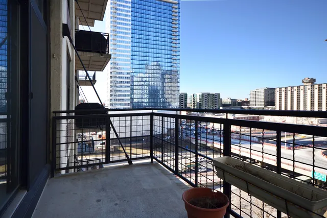 a view of balcony with a potted plant and a table
