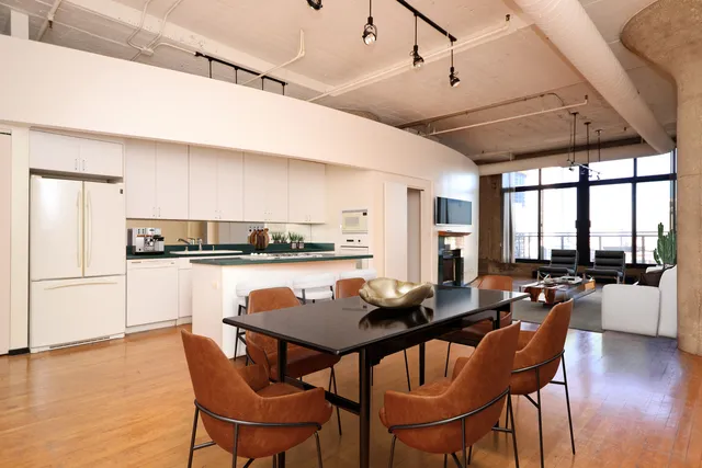 a dining room with furniture and wooden floor