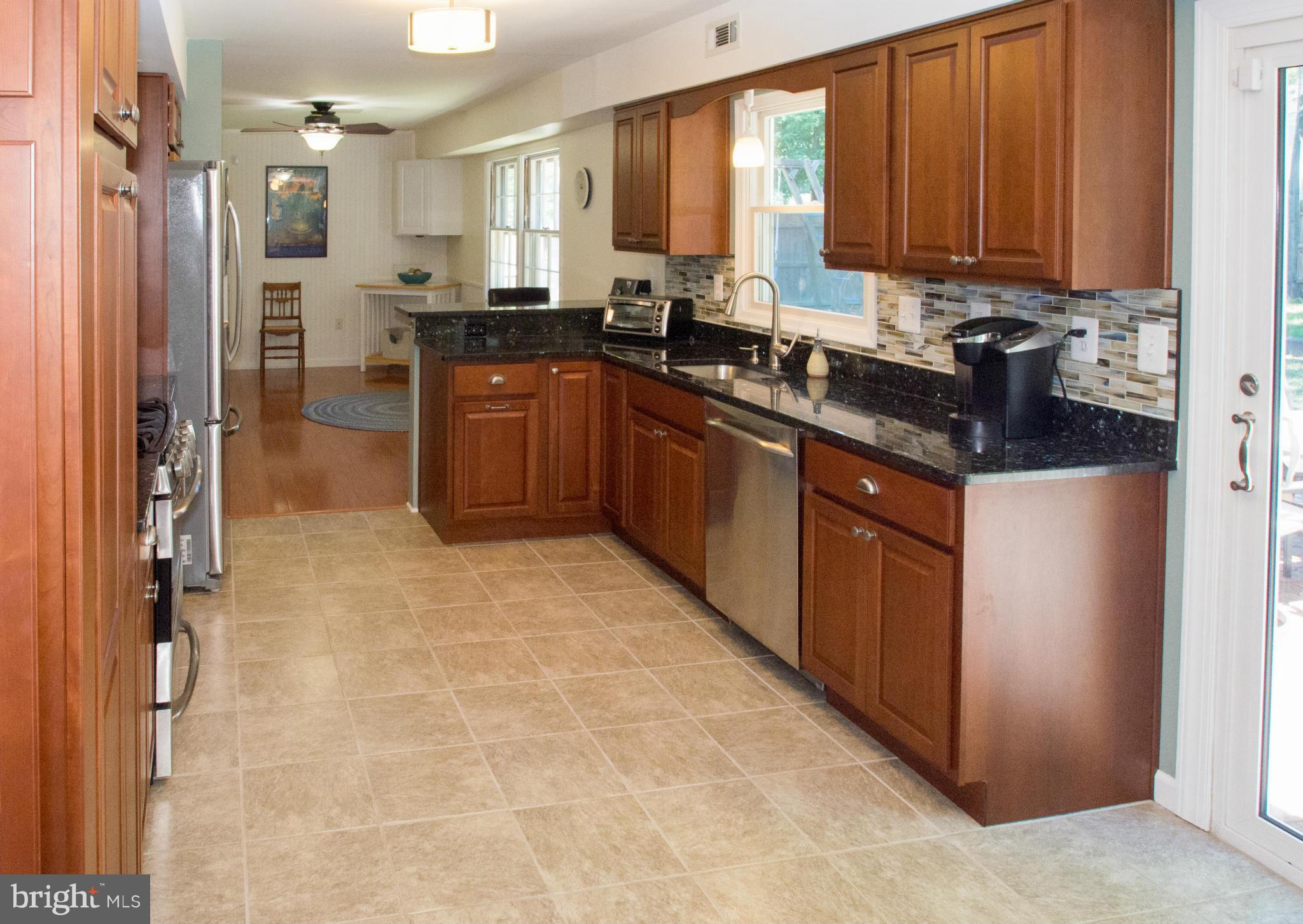1712 Tarleton Way Crofton, MD 21114 - Photo 4 of 26 a kitchen with stainless steel appliances granite countertop a sink stove and refrigerator