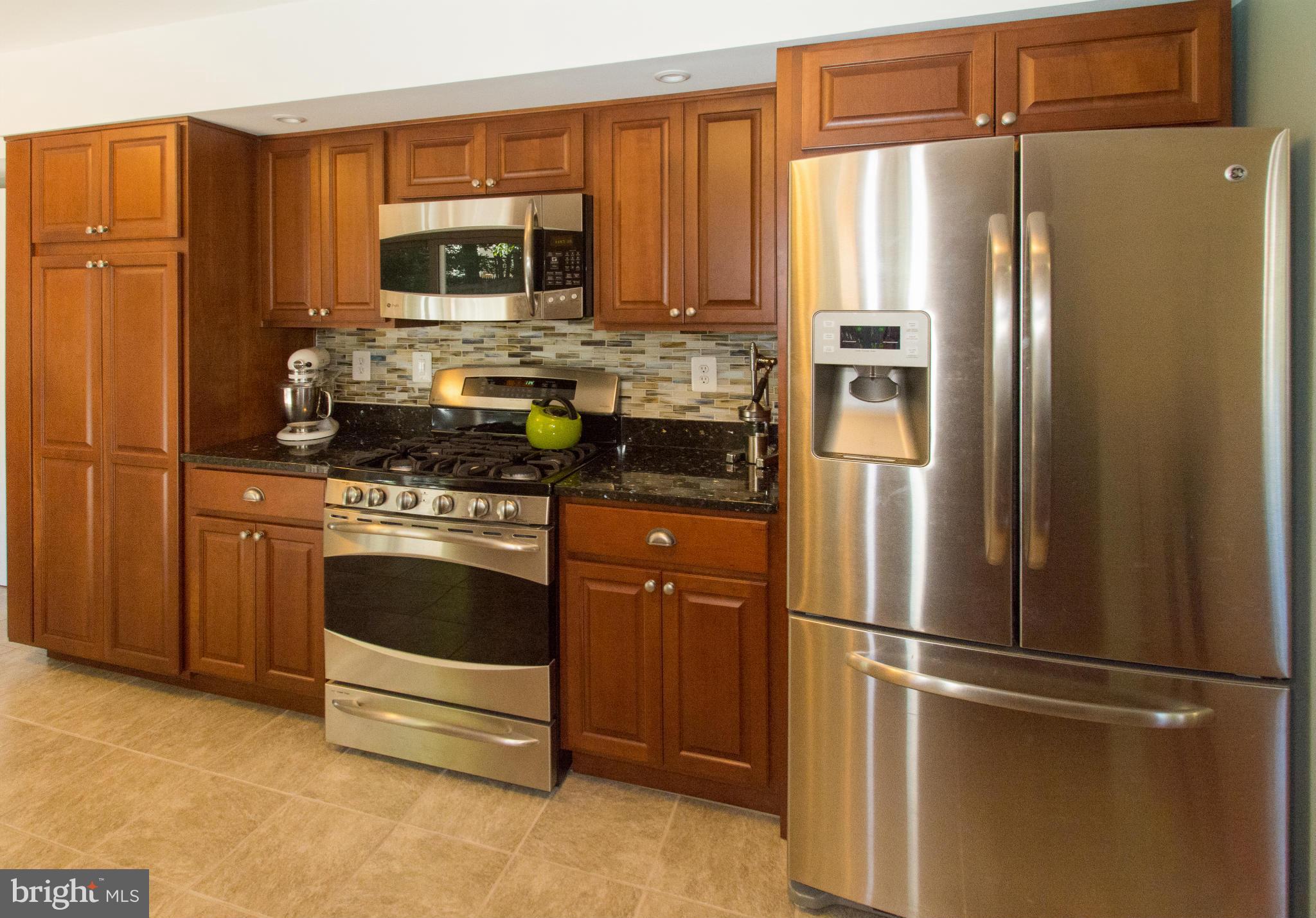 1712 Tarleton Way Crofton, MD 21114 - Photo 5 of 26 a kitchen with stainless steel appliances granite countertop a refrigerator and a stove top oven