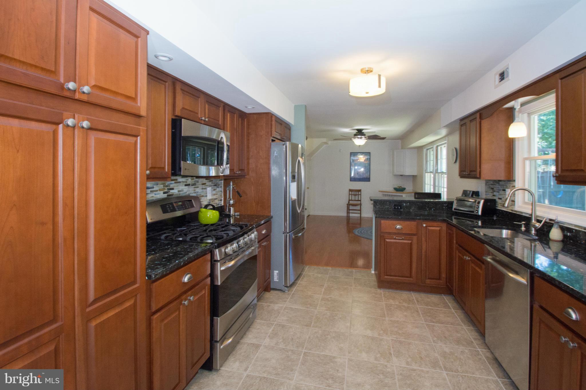 1712 Tarleton Way Crofton, MD 21114 - Photo 6 of 26 a kitchen with stainless steel appliances granite countertop a refrigerator a stove top oven and a sink