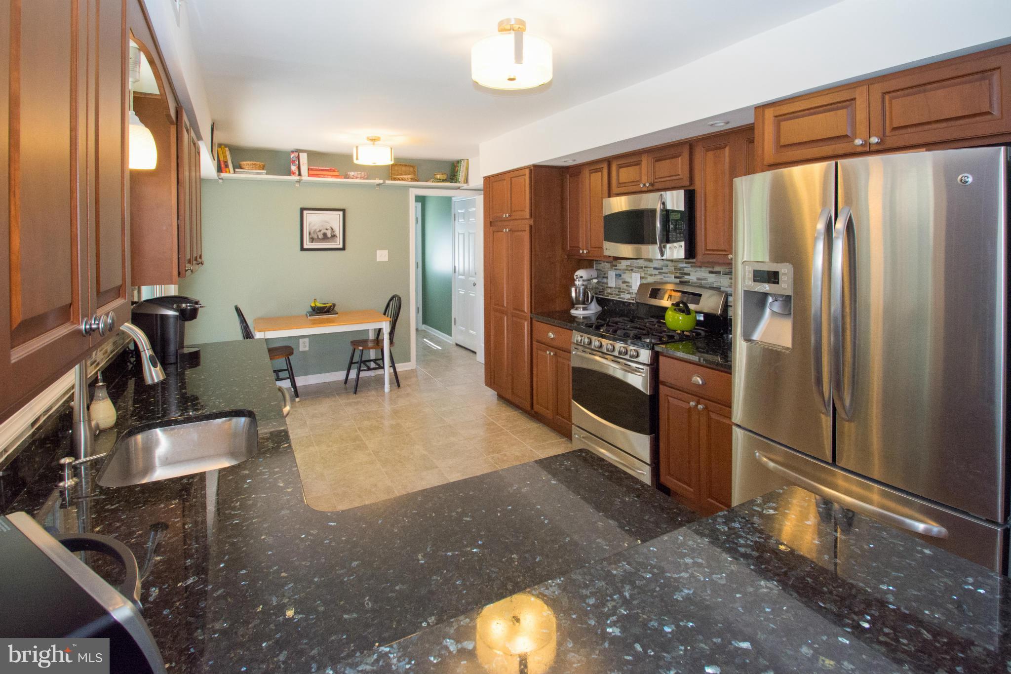 1712 Tarleton Way Crofton, MD 21114 - Photo 7 of 26 a kitchen with stainless steel appliances granite countertop a refrigerator and a stove top oven