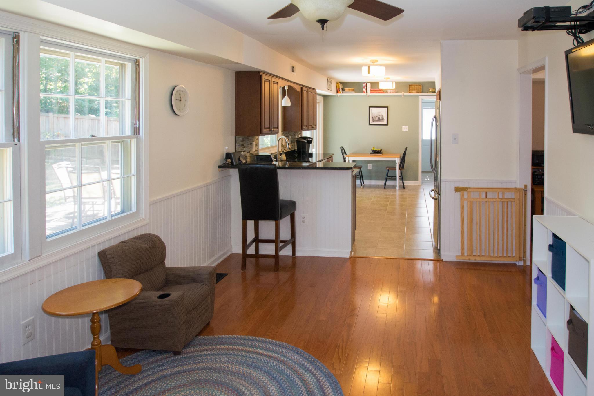 1712 Tarleton Way Crofton, MD 21114 - Photo 8 of 26 a living room with couches and kitchen view with wooden floor