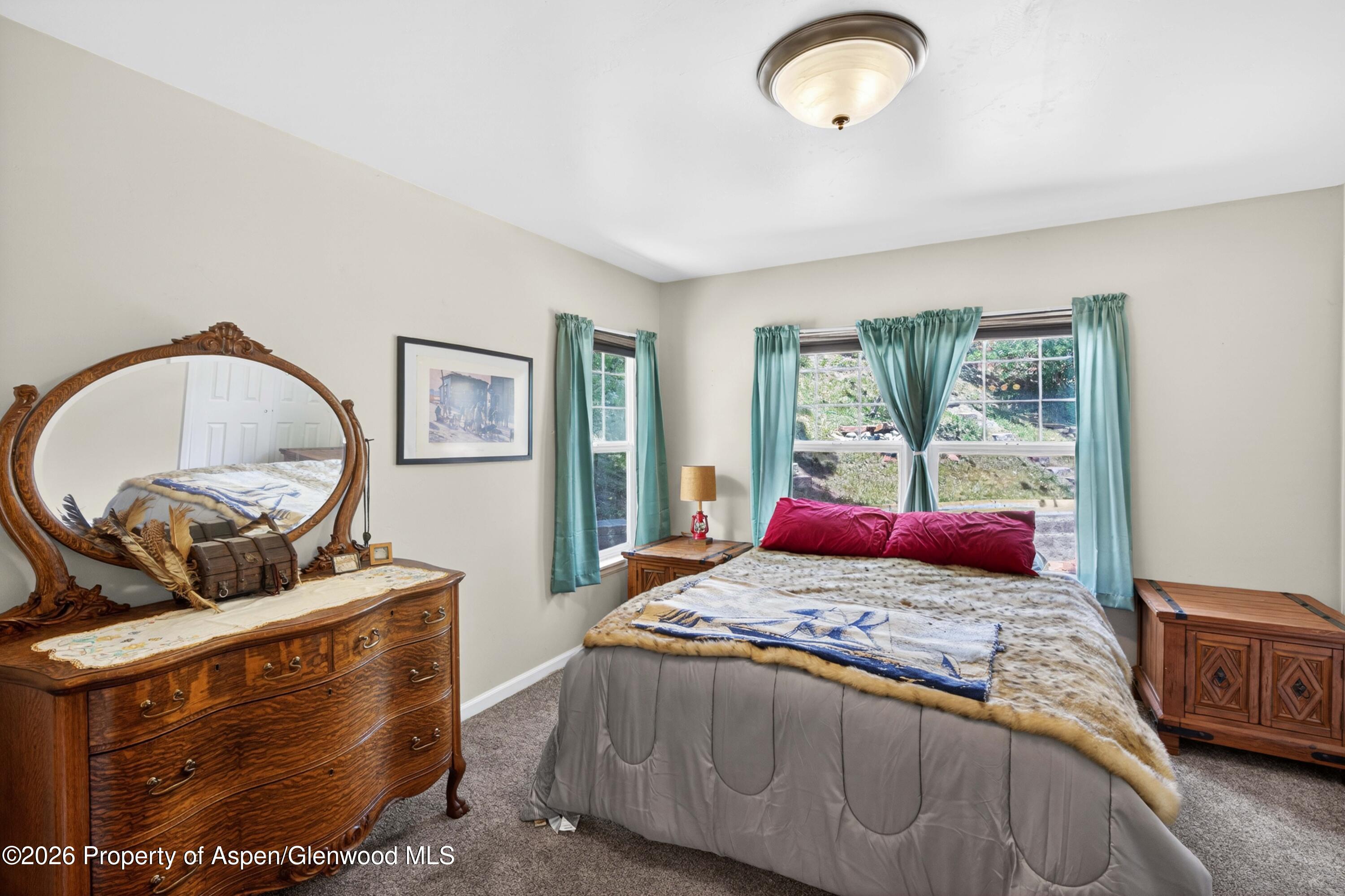 608 Lariat Loop New Castle, CO 81647 - Photo 15 of 32 a bedroom with a bed and dresser