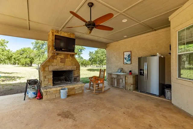 a view of a room with a tv outdoor seating area