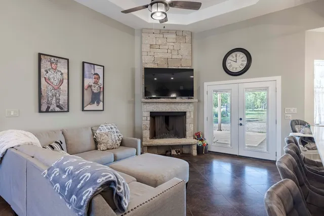 a living room with furniture a flat screen tv and a fireplace