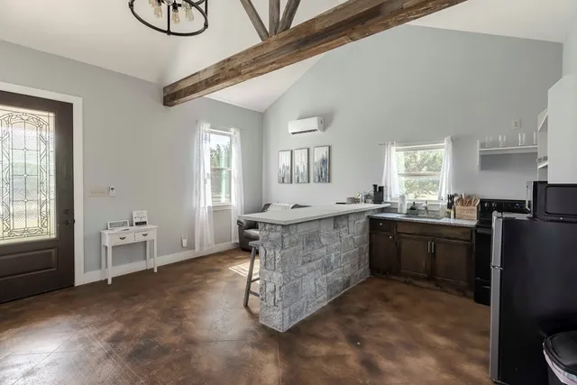 a large kitchen with sink a refrigerator and microwave
