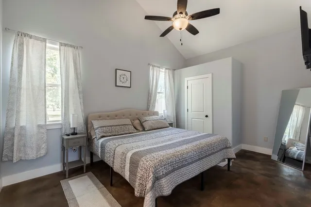 a bedroom with a bed and a window