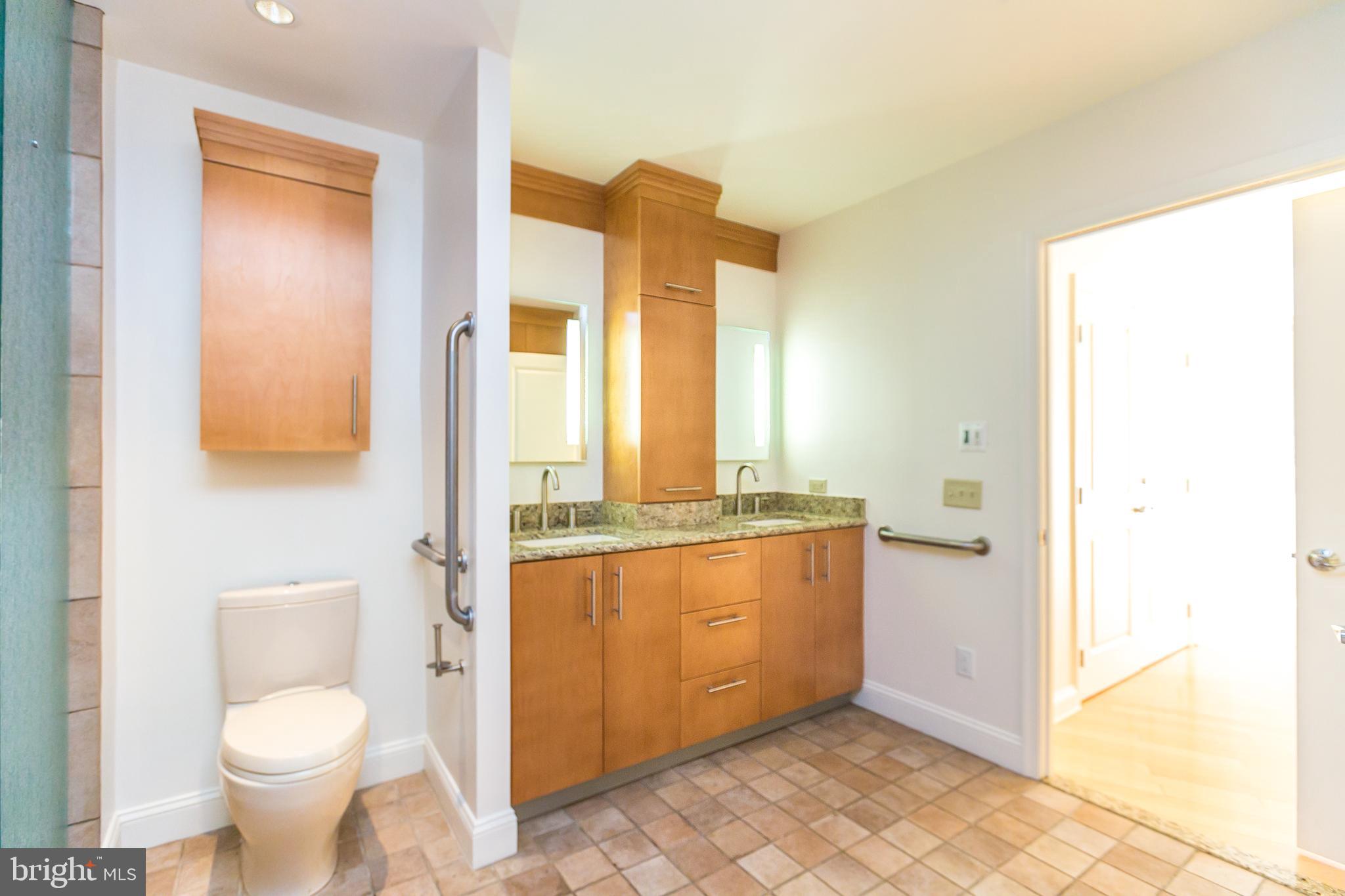 717 President Street, Unit 401 Baltimore, MD 21202 - Photo 19 of 36 a bathroom with a granite countertop sink and a mirror