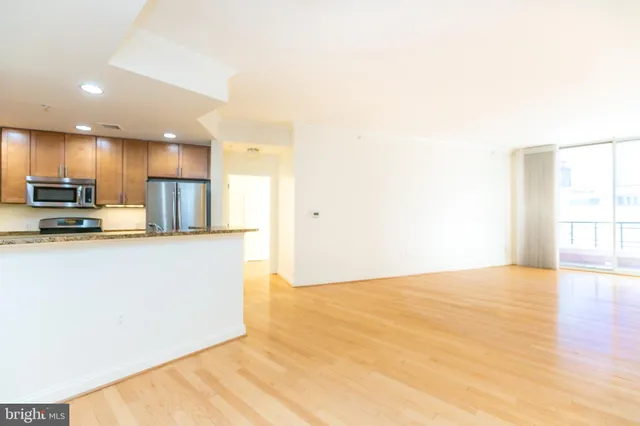 a kitchen with stainless steel appliances a refrigerator and a stove top oven