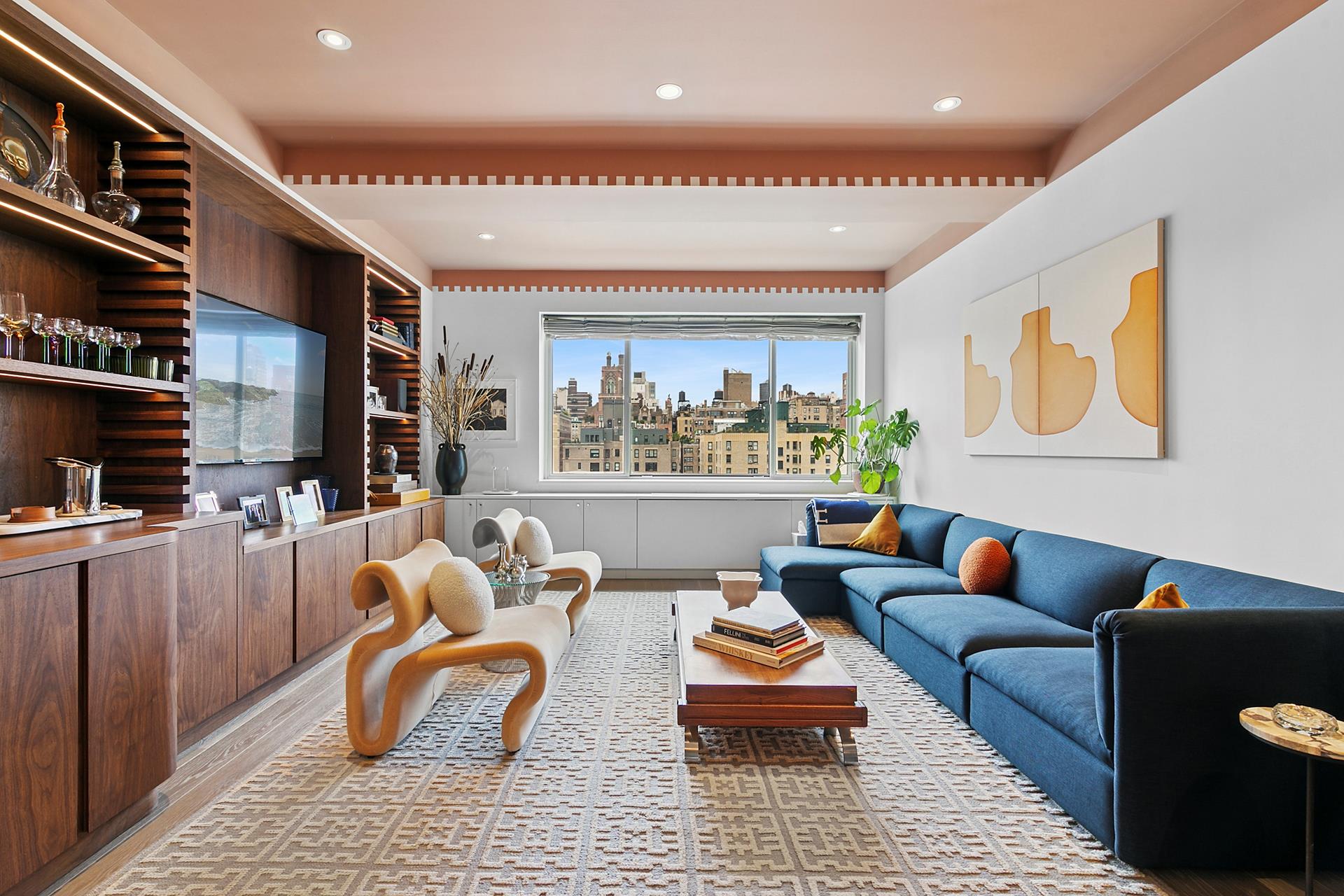 a living room with furniture a rug and a flat screen tv