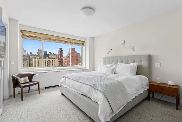 a bathroom with a sink a toilet a mirror and shower