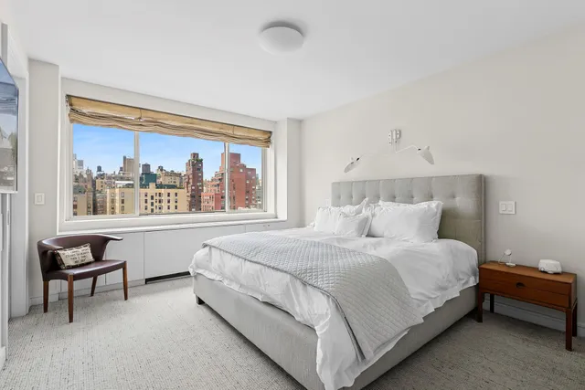 a bathroom with a sink a toilet a mirror and shower