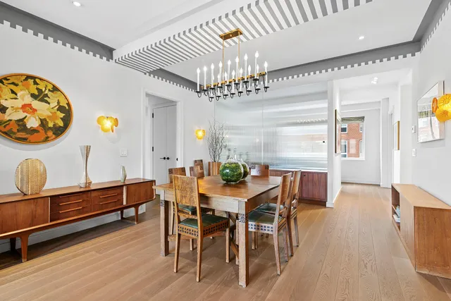 a view of a dining room with furniture and chandelier