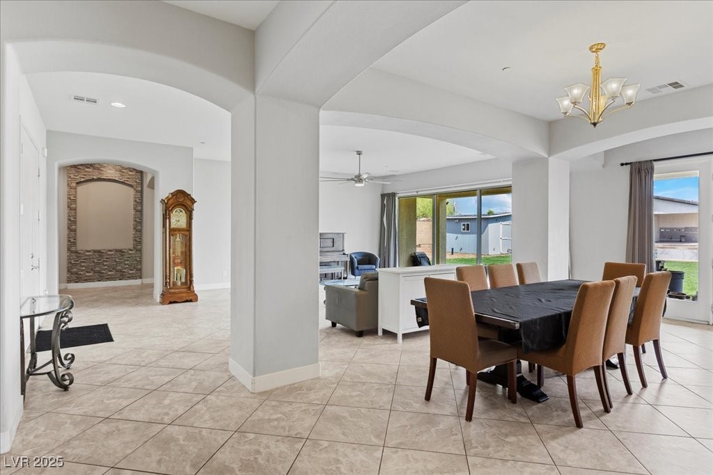 259 Milan Street Henderson, NV 89015 - Photo 13 of 99 Dining room with arched walkways, ceiling fan, and light tile patterned floors