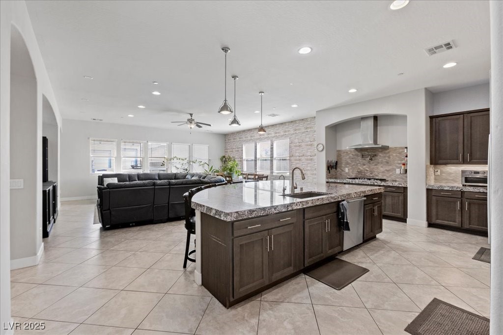 259 Milan Street Henderson, NV 89015 - Photo 20 of 99 Kitchen featuring dark brown cabinets, pendant lighting, ceiling fan, recessed lighting, and a kitchen breakfast bar