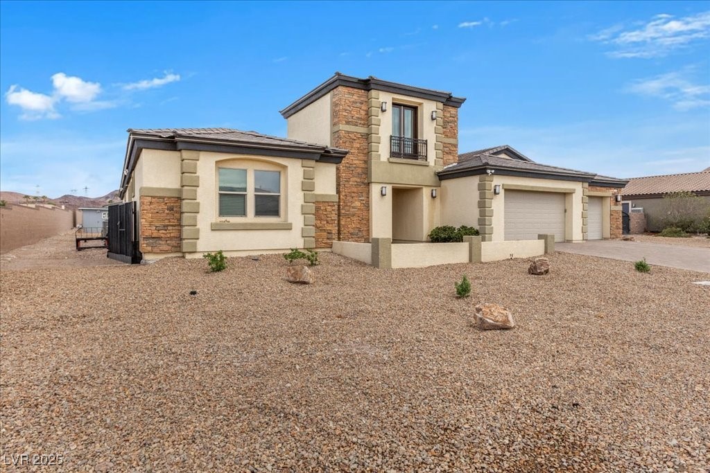 259 Milan Street Henderson, NV 89015 - Photo 4 of 99 View of front of home with stone siding, stucco siding, driveway, an attached garage, and a tile roof
