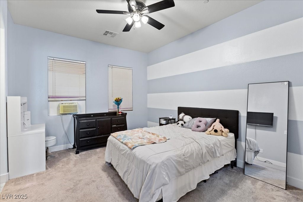 259 Milan Street Henderson, NV 89015 - Photo 44 of 99 Bedroom with light colored carpet and a ceiling fan