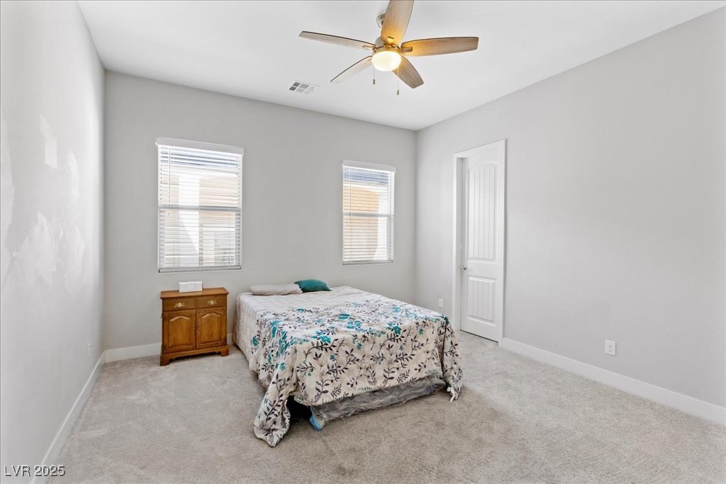 259 Milan Street Henderson, NV 89015 - Photo 47 of 99 Bedroom featuring light carpet and ceiling fan