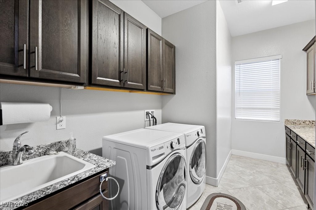 259 Milan Street Henderson, NV 89015 - Photo 55 of 99 Washroom with cabinet space, washer and dryer, and light tile patterned floors