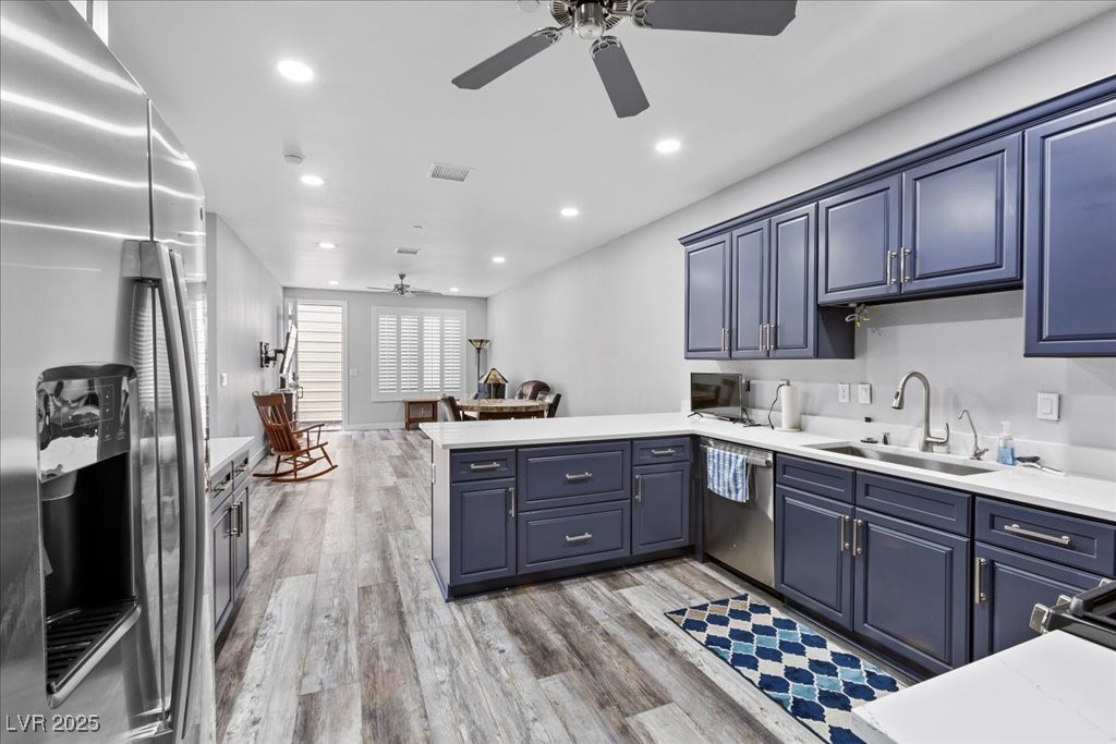259 Milan Street Henderson, NV 89015 - Photo 99 of 99 Guest house kitchen featuring stainless steel appliances, a peninsula, light wood finished floors, open floor plan, and recessed lighting