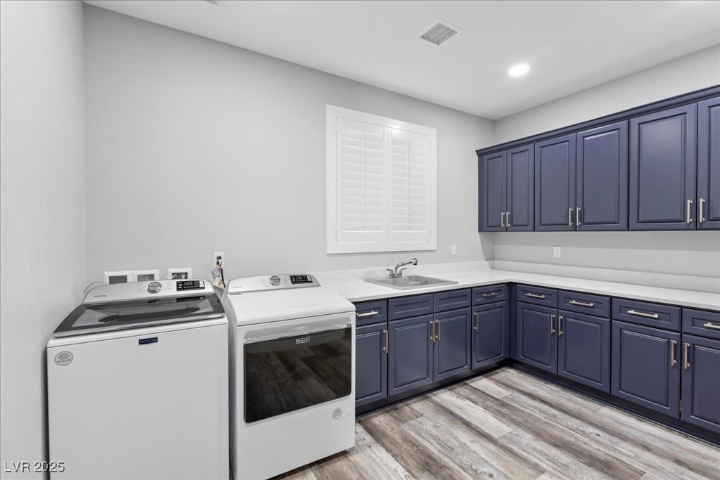 259 Milan Street Henderson, NV 89015 - Photo 66 of 99 Guest house laundry area featuring washing machine and dryer, light wood-style flooring, cabinet space, and recessed lighting