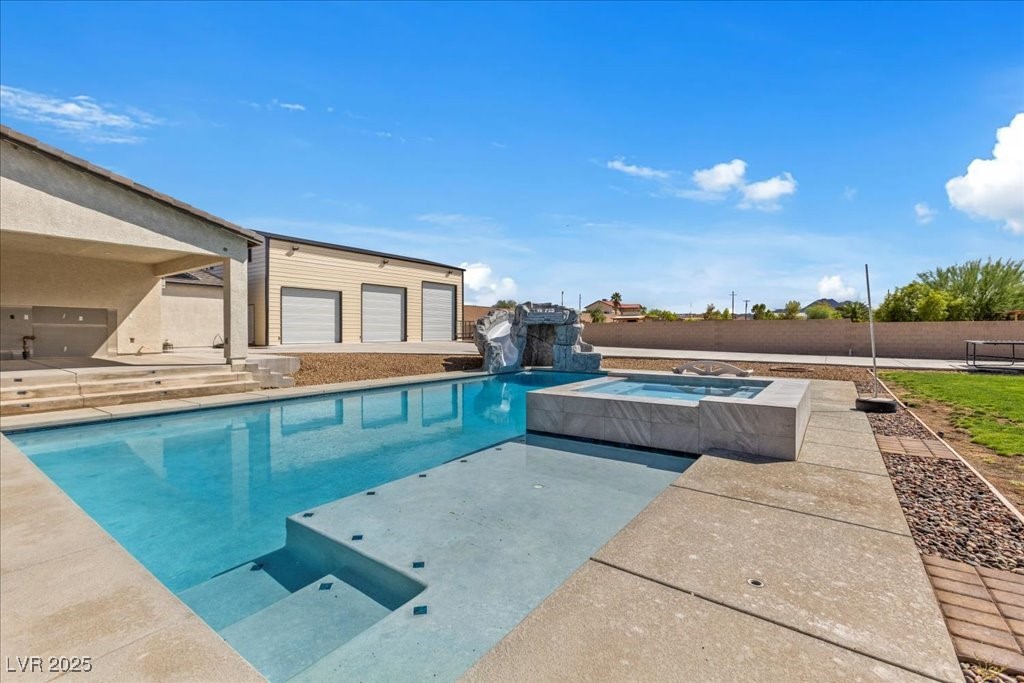 259 Milan Street Henderson, NV 89015 - Photo 86 of 99 View of swimming pool featuring a patio area, a fenced backyard, and a pool with connected hot tub