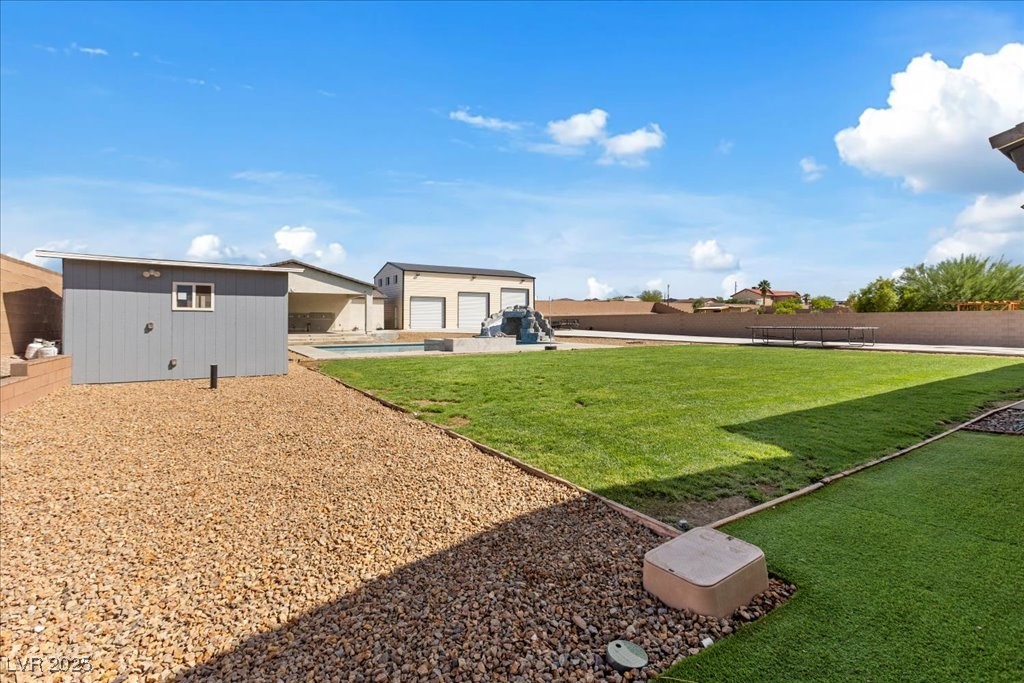 259 Milan Street Henderson, NV 89015 - Photo 89 of 99 Fenced backyard with an outdoor structure, a patio, and an outdoor pool