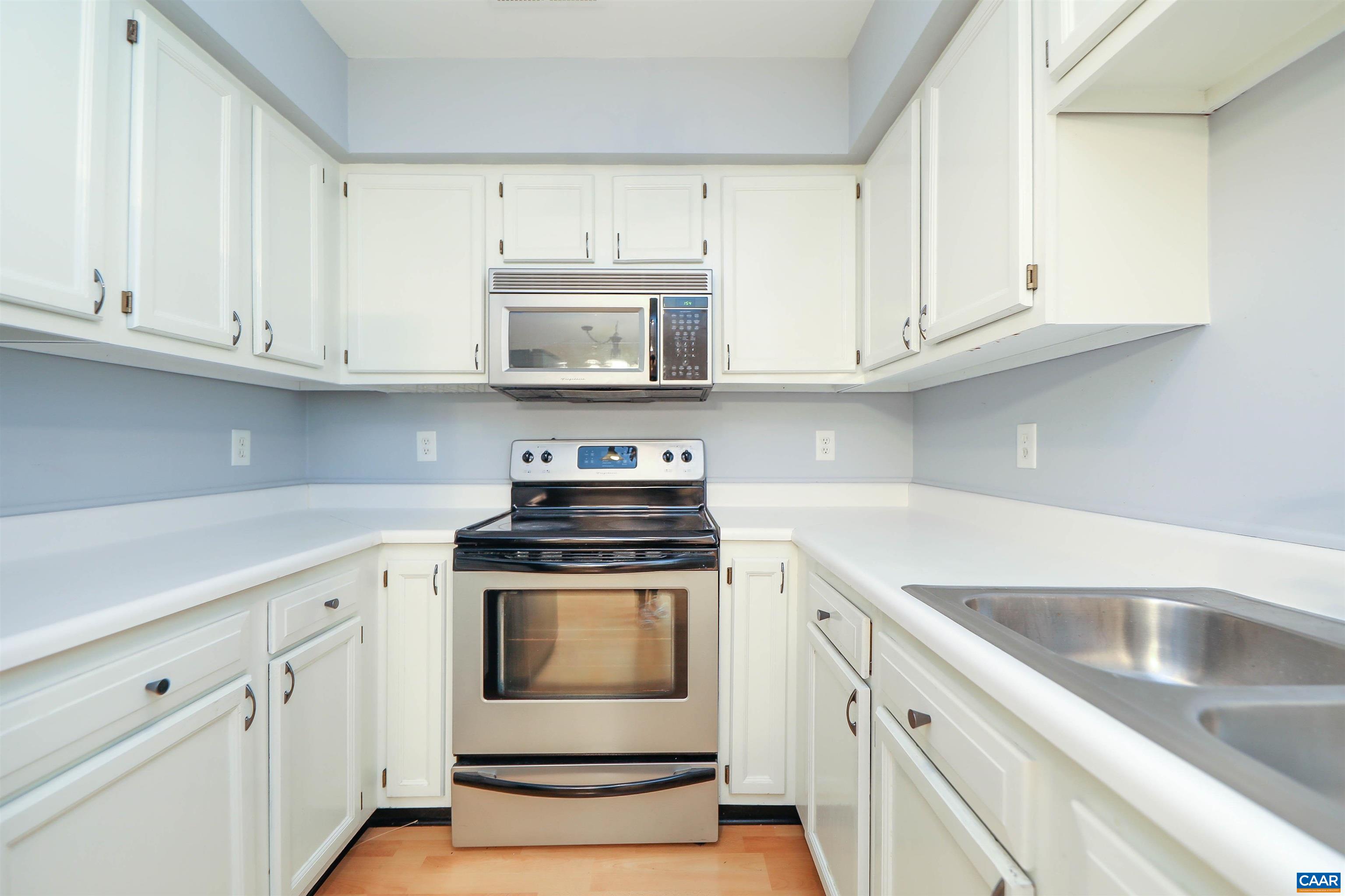 Undisclosed Address Charlottesville, VA 22902 - Photo 12 of 49 a kitchen with white cabinets and white appliances