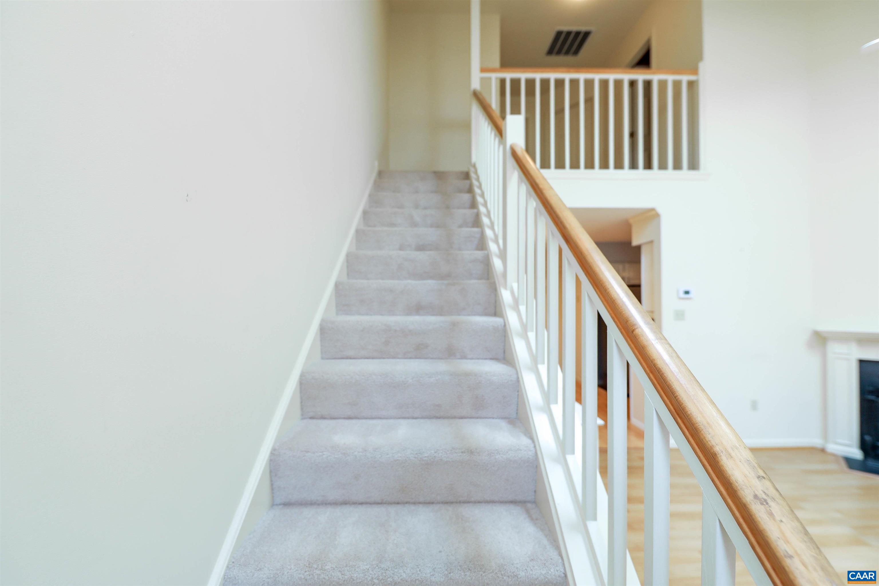 Undisclosed Address Charlottesville, VA 22902 - Photo 6 of 49 a view of staircase with lots of frames on wall and wooden floor