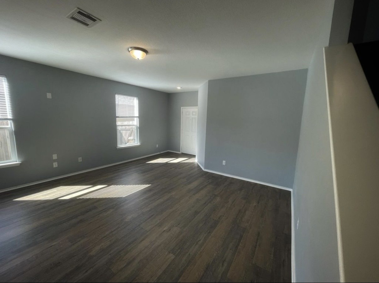 13905 Inaugural Street Manor, TX 78653 - Photo 3 of 26 Spare room with dark wood finished floors and baseboards