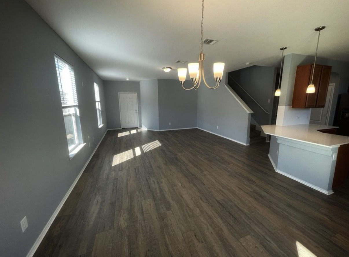 13905 Inaugural Street Manor, TX 78653 - Photo 7 of 26 Unfurnished dining area with suspended lighting and dark wood finished floors