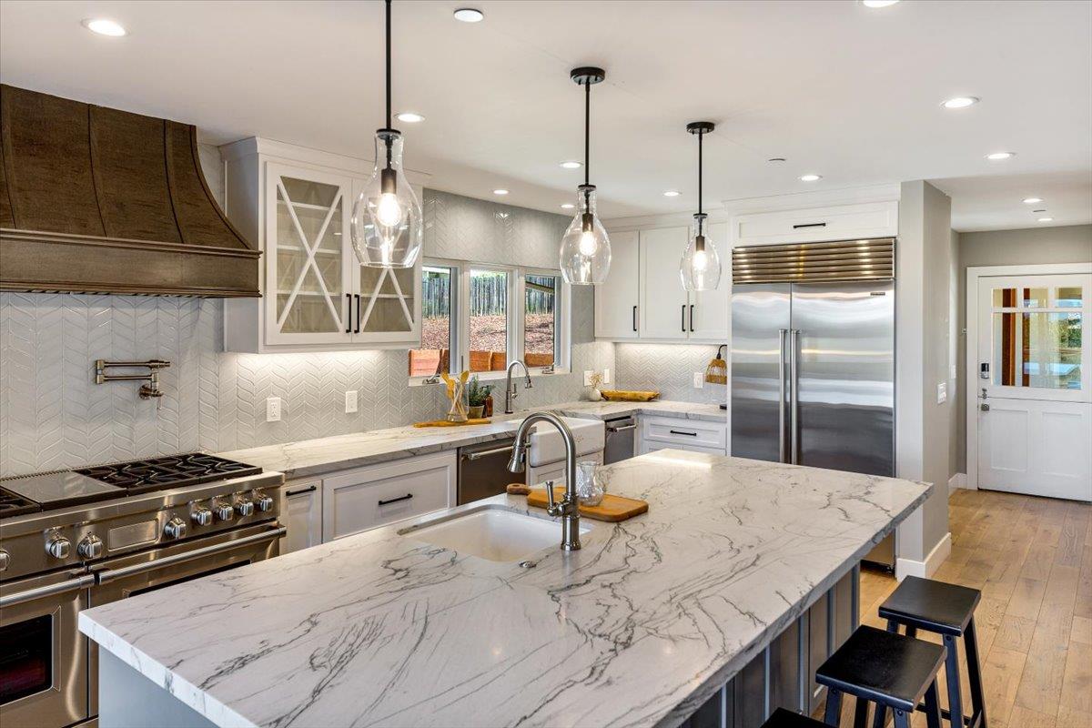 66 Rancho Road Carmel Valley, CA 93924 - Photo 12 of 59 a kitchen with a table chairs stove and kitchen island