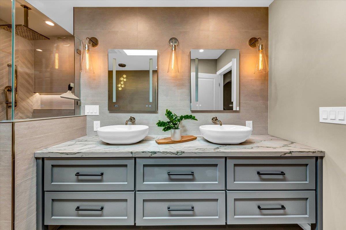 66 Rancho Road Carmel Valley, CA 93924 - Photo 28 of 59 a bathroom with a granite countertop sink and a mirror