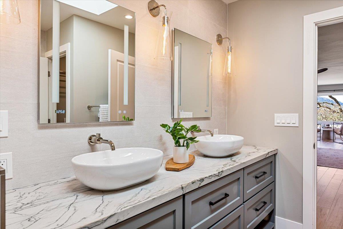 66 Rancho Road Carmel Valley, CA 93924 - Photo 29 of 59 a bathroom with a granite countertop sink and a mirror