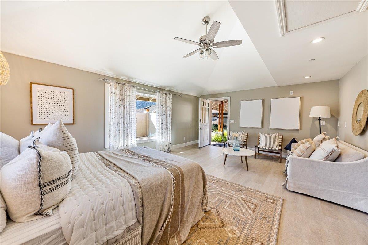 66 Rancho Road Carmel Valley, CA 93924 - Photo 37 of 59 a spacious bedroom with a bed a couch and a window