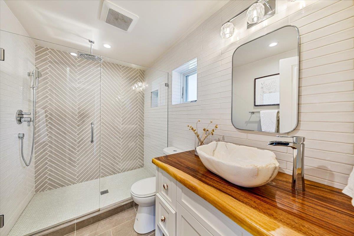66 Rancho Road Carmel Valley, CA 93924 - Photo 38 of 59 a bathroom with a sink a toilet and shower