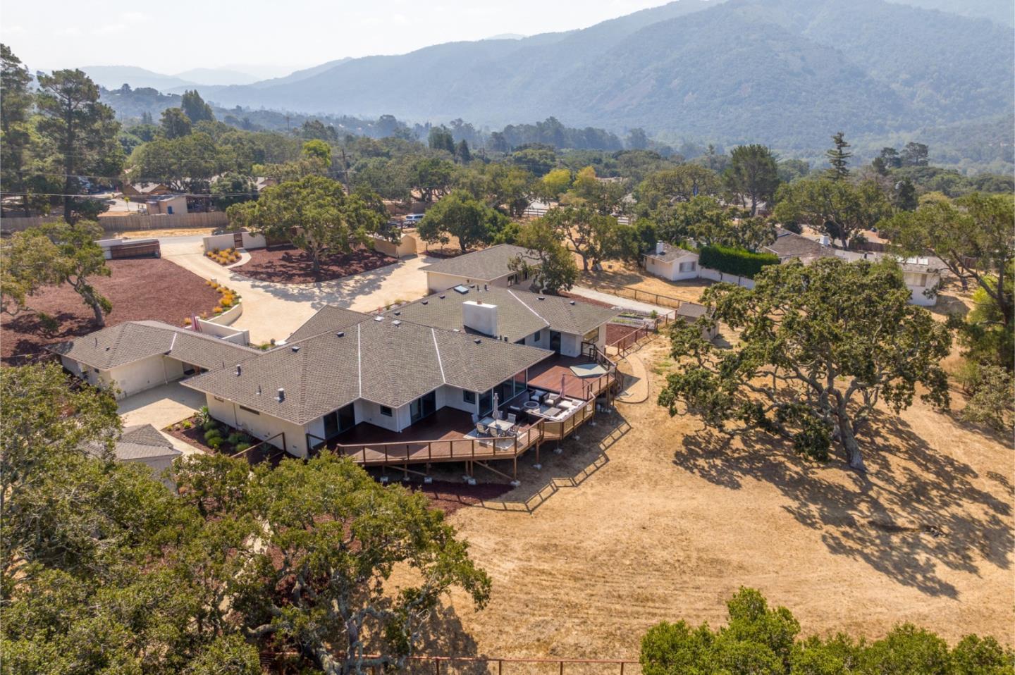 66 Rancho Road Carmel Valley, CA 93924 - Photo 54 of 59 a view of a house with a mountain in the background