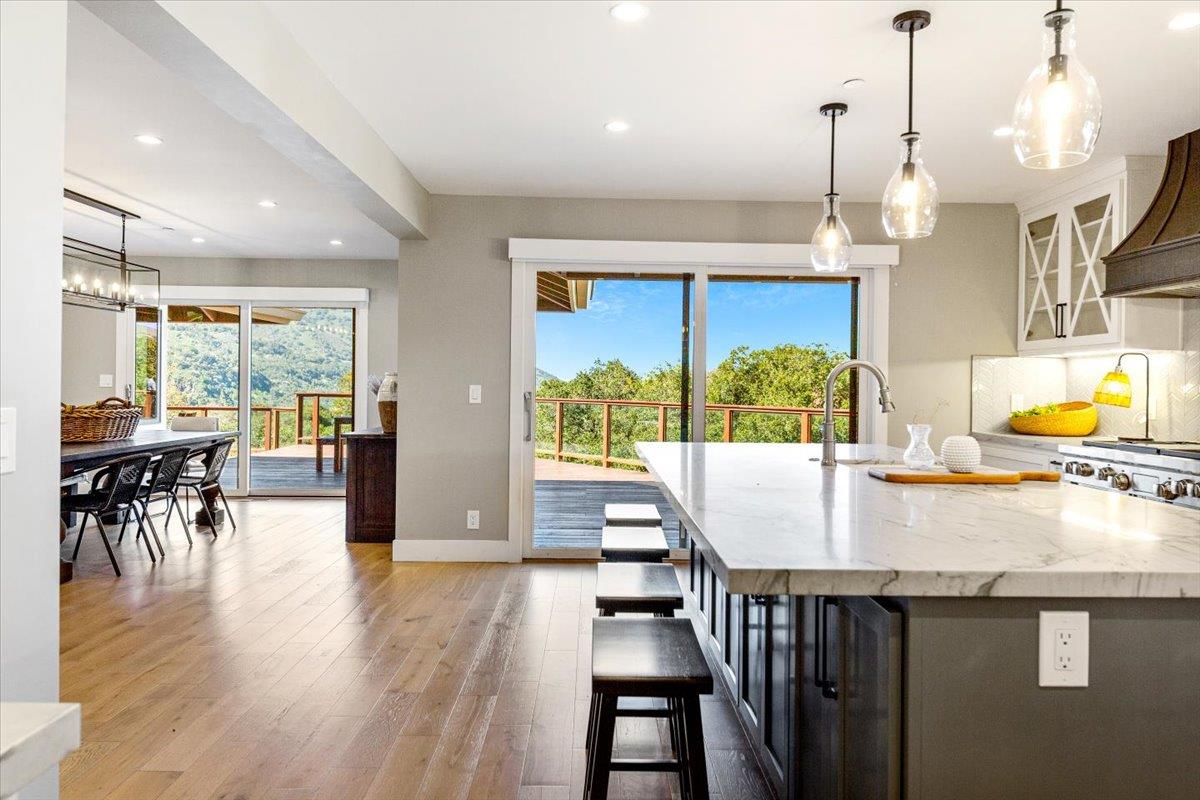 66 Rancho Road Carmel Valley, CA 93924 - Photo 8 of 59 a kitchen with a table chairs and wooden floor