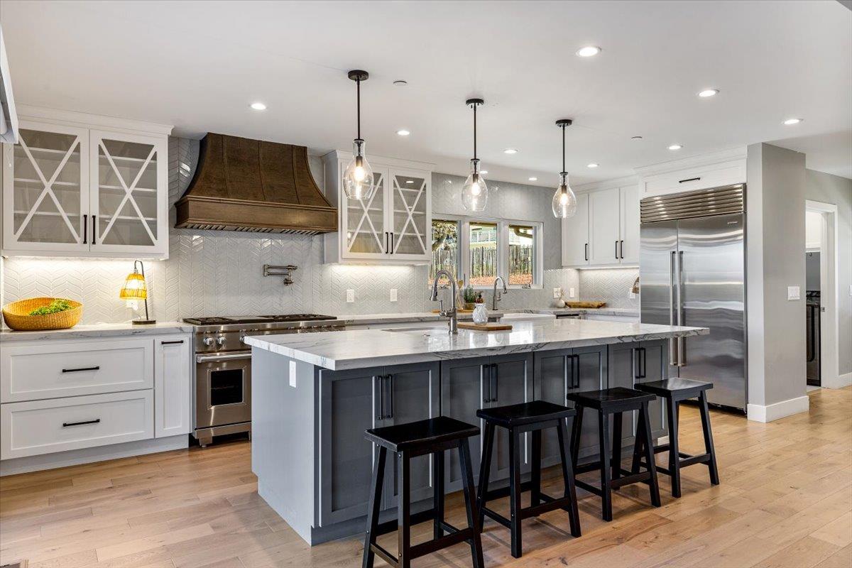 66 Rancho Road Carmel Valley, CA 93924 - Photo 9 of 59 a kitchen with kitchen island a stove a table and chairs in it