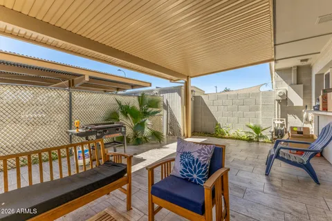 a view of a chairs and table in the balcony