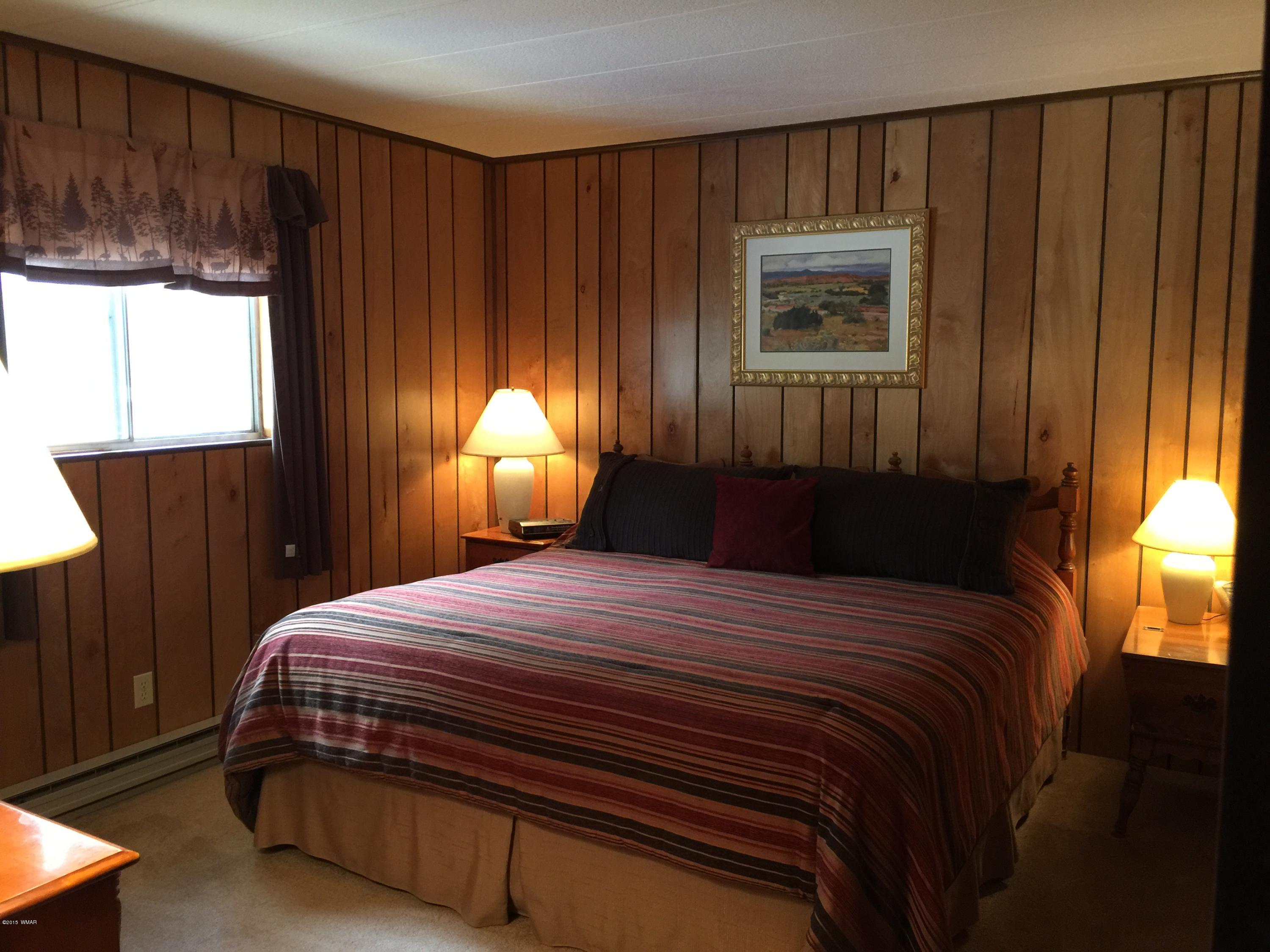 261 Powderhorn Lane Lakeside, AZ 85929 - Photo 20 of 31 a bedroom with a bed and a window