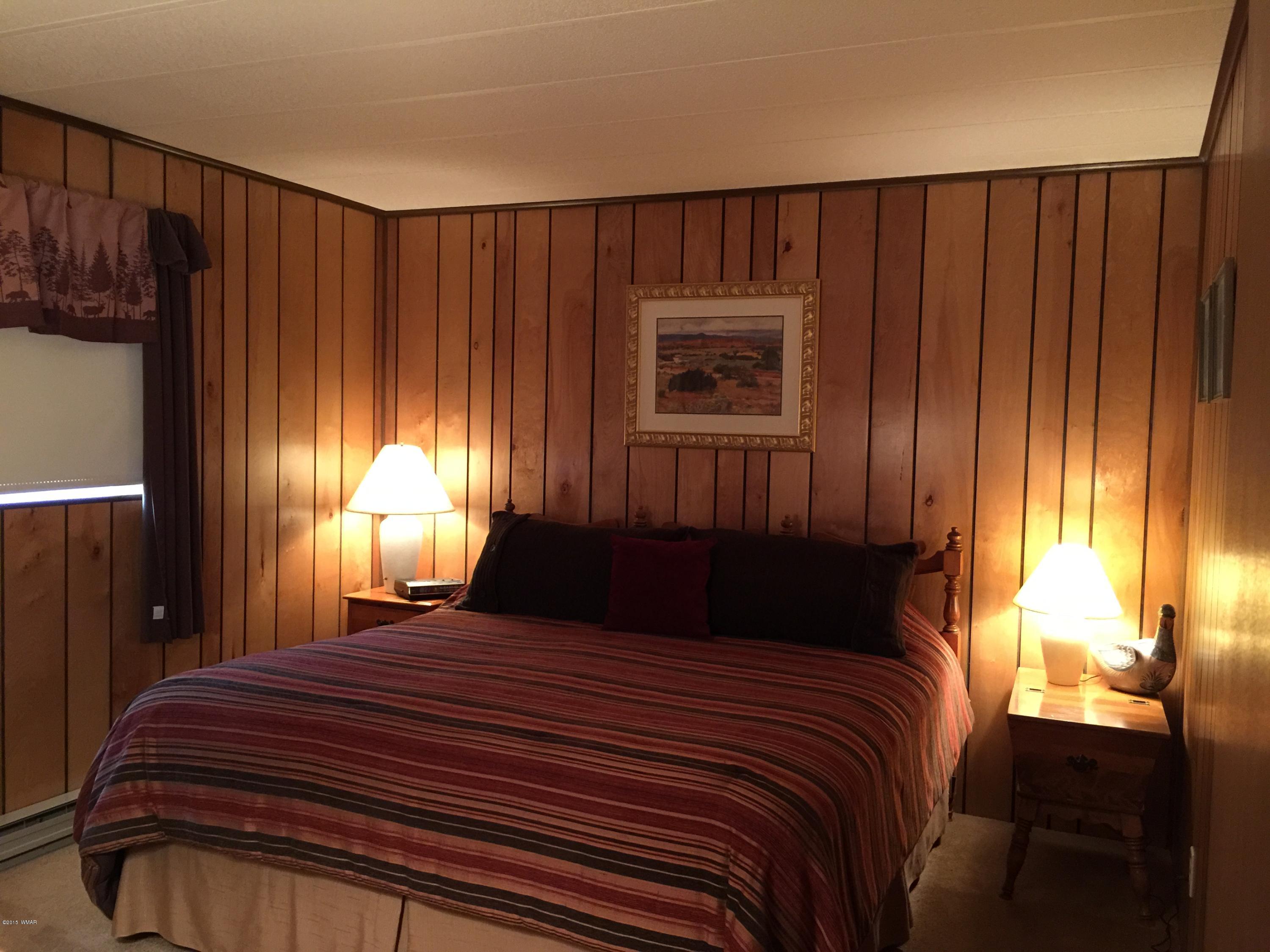 261 Powderhorn Lane Lakeside, AZ 85929 - Photo 21 of 31 a bedroom with a bed and a window
