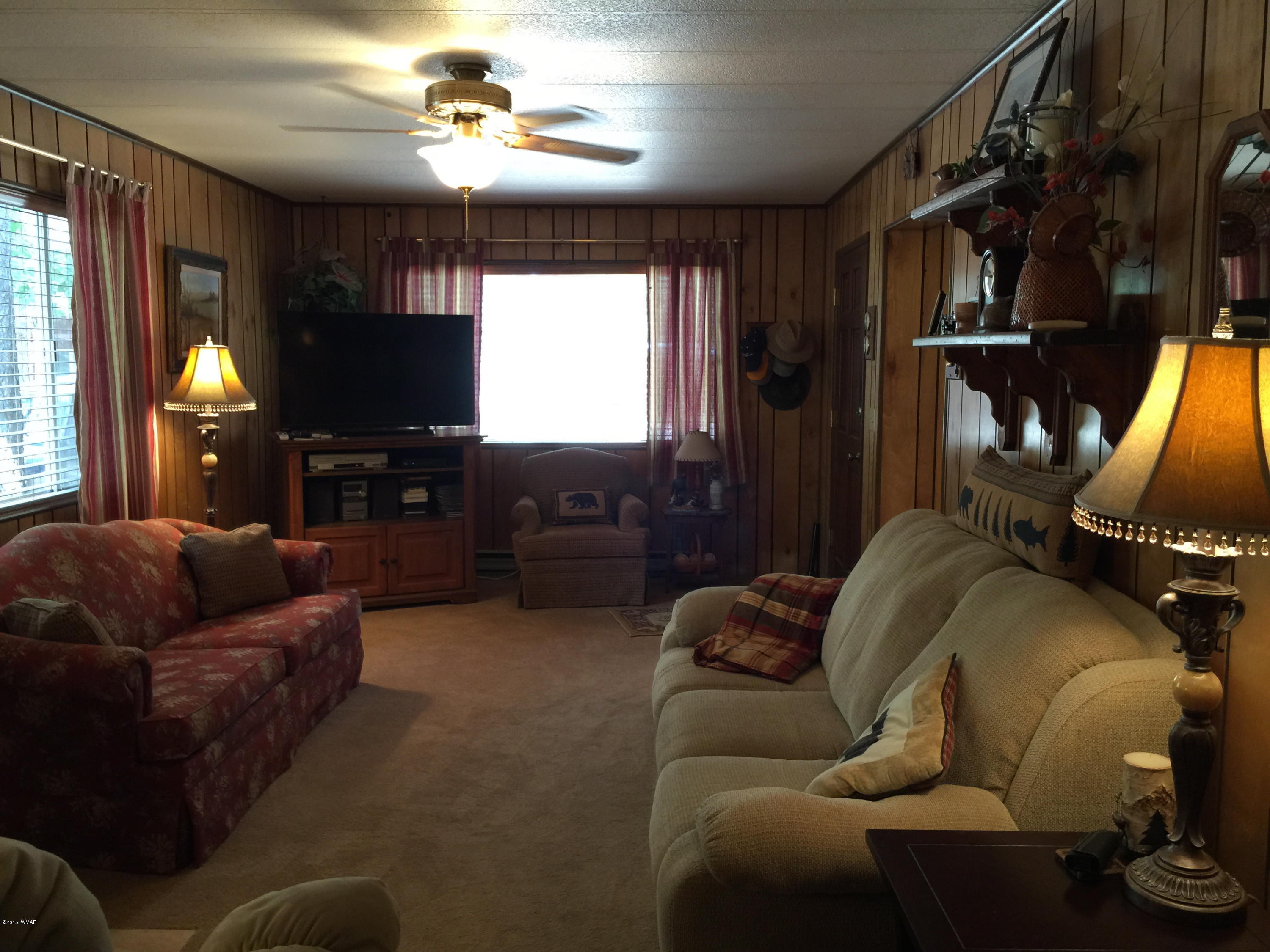 261 Powderhorn Lane Lakeside, AZ 85929 - Photo 26 of 31 a living room with furniture ceiling fan and a window