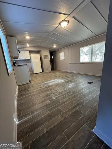 a large kitchen with a stove and a refrigerator