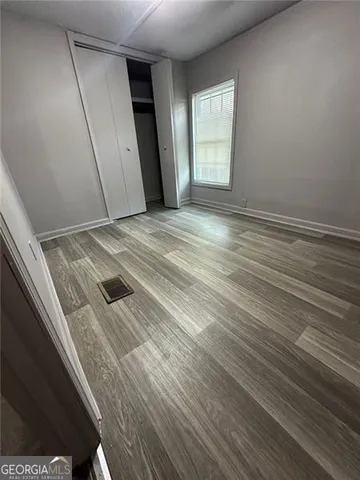 wooden floor in an empty room with a window