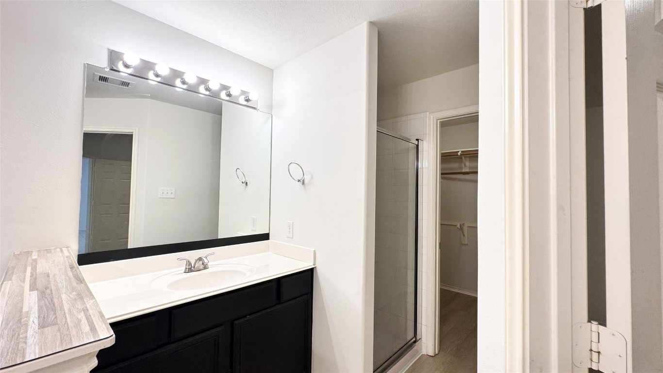 6818 Hampden Point Court Houston, TX 77040 - Photo 11 of 17 a bathroom with a double vanity sink and mirror