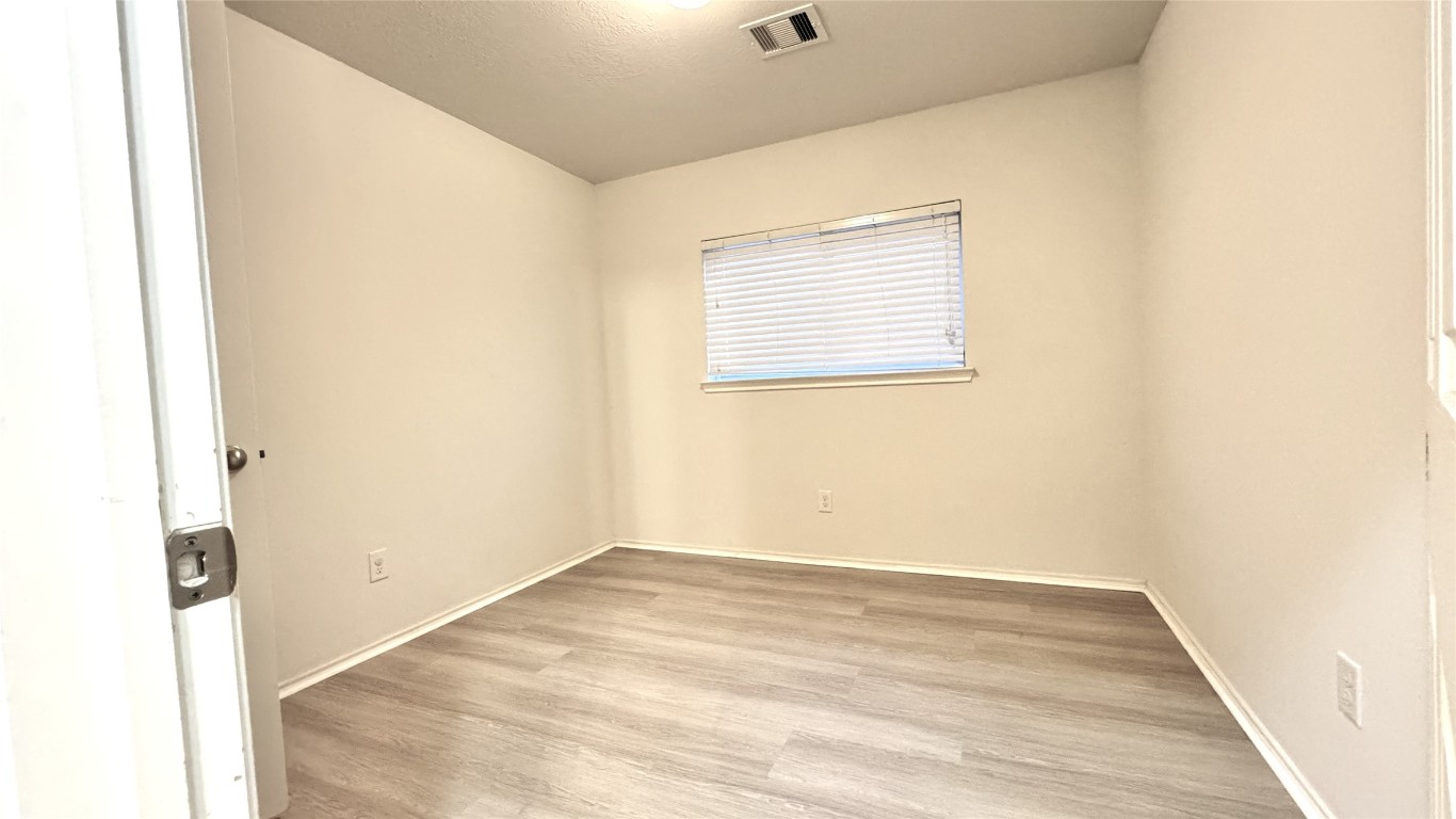 6818 Hampden Point Court Houston, TX 77040 - Photo 14 of 17 a view of a room with wooden floor