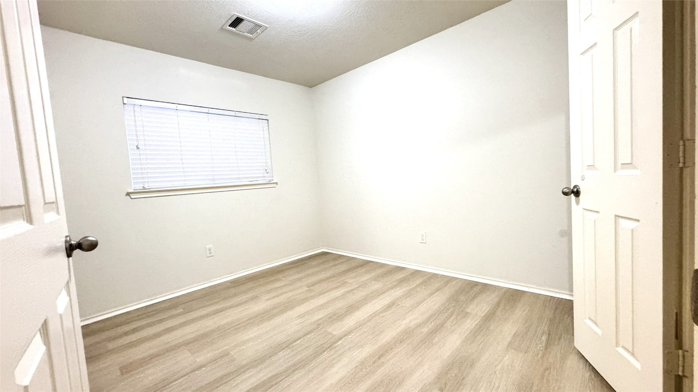 6818 Hampden Point Court Houston, TX 77040 - Photo 16 of 17 a view of a room with wooden floor and a window