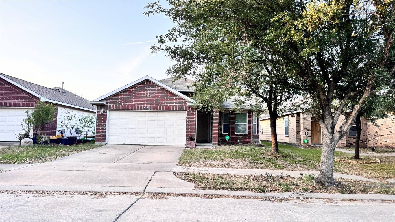 6818 Hampden Point Court Houston, TX 77040 - Photo 2 of 17 a front view of a house with a yard and garage
